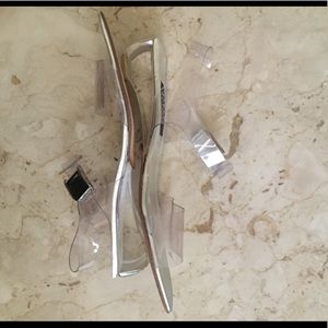 Stuart Weitzman Clear Flat Sandal w/Lucite Heel.